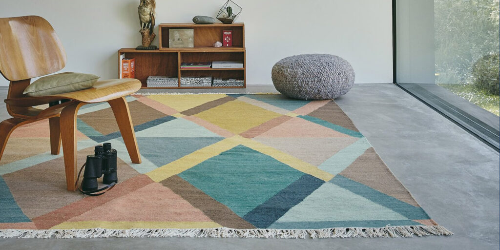 Barbers Flooring | Guide | image showing a multi color rug in a bedroom